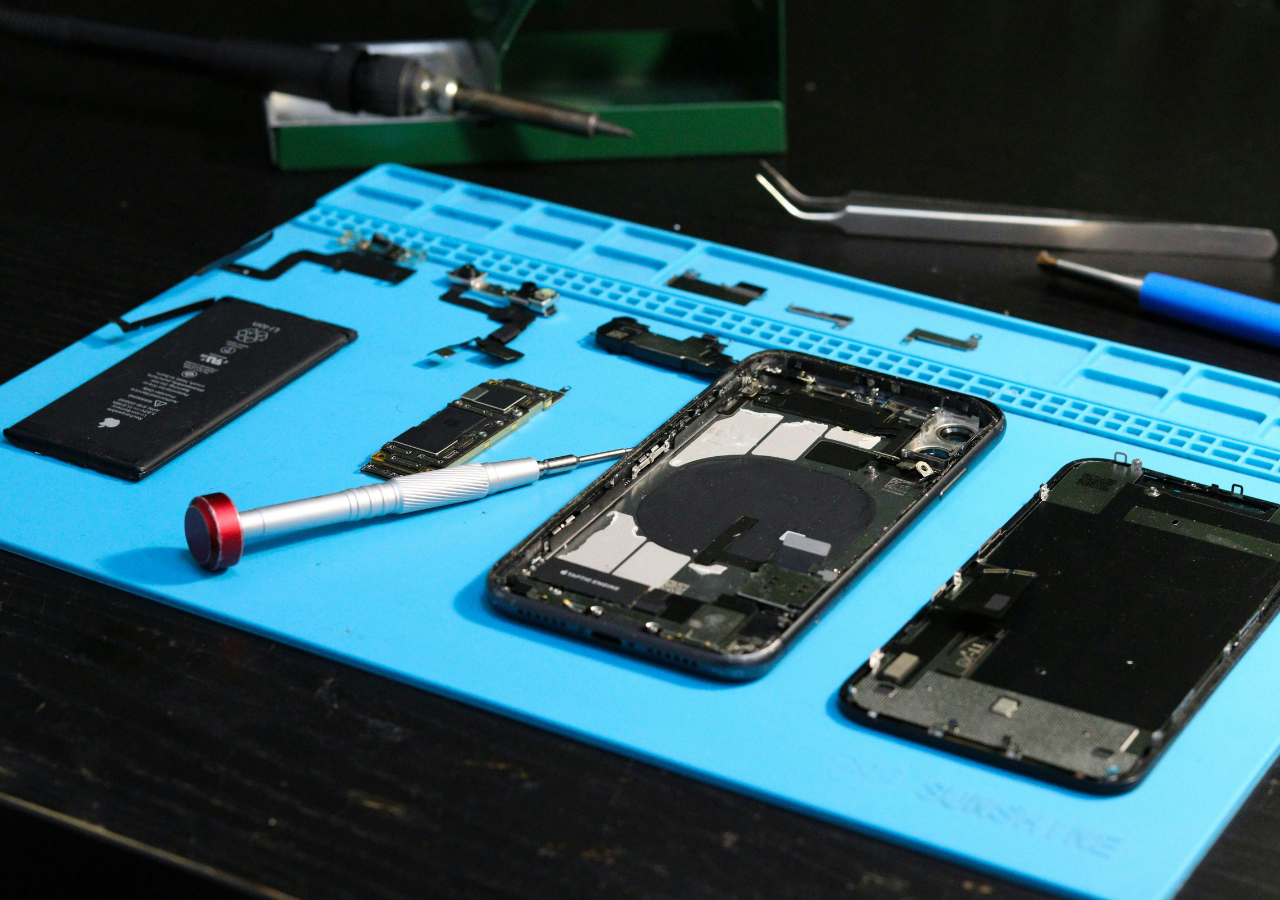 Technician completing an Apple repair using genuine parts